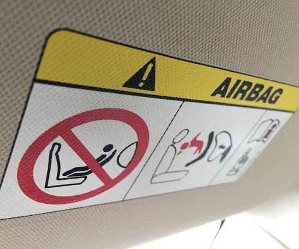 Airbag warning label on sun visor